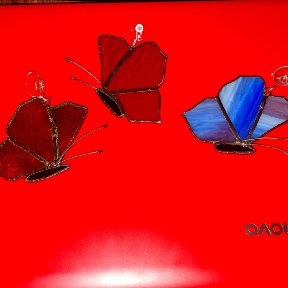 Three homemade stained glass butterflies.